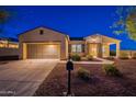 Charming single-story home featuring a stone-accented entrance and a well-manicured front yard at 21913 N Pedregosa Ct, Sun City West, AZ 85375