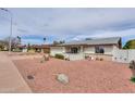 Inviting home with a well-maintained exterior, front yard desert landscaping, and neighborhood views at 2504 E Riviera Dr, Tempe, AZ 85282