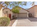 Attached two-car garage with paved driveway surrounded by desert landscaping at 2580 E Boston St, Gilbert, AZ 85295