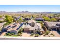 Expansive aerial view of a desert home showcasing the beautiful tile roof and desert landscaping at 26015 N 85Th Dr, Peoria, AZ 85383