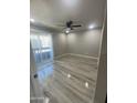 Bedroom with wood-look flooring, a ceiling fan, and a sliding glass door leading to an outdoor area at 2662 N 43Rd Ave # B, Phoenix, AZ 85009
