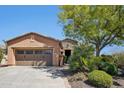 Charming home featuring a well-manicured front yard, a desert landscape, and a two-car garage at 28351 N 130Th Dr, Peoria, AZ 85383