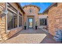 Inviting front entrance with stone accents, manicured plants, and an elegant glass door at 3529 N Boulder Canyon St, Mesa, AZ 85207