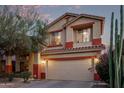 Two-story home featuring a two-car garage, desert landscaping, and neutral color palette at 36469 W Alhambra St, Maricopa, AZ 85138