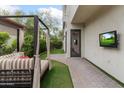 Outdoor space featuring patio, lounge seating, manicured lawn, and an outdoor mounted television for entertainment at 4216 N 27Th St # 108, Phoenix, AZ 85016