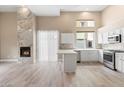 Living area boasts a fireplace, an open-concept layout, and a kitchen with white cabinetry and stone countertops at 4216 N 27Th St # 108, Phoenix, AZ 85016