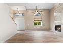 Spacious living room featuring wood floors, a fireplace, and natural light coming in through large windows at 4216 N 27Th St # 108, Phoenix, AZ 85016