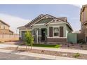 Beautiful single-Gathering home featuring manicured landscaping, stylish wood accents, and a welcoming entrance at 4265 E John St, Gilbert, AZ 85295