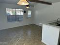 Bright dining area with tile floors, a ceiling fan, and access to the backyard at 510 N Alma School Rd # 259, Mesa, AZ 85201