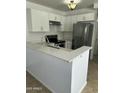 Modern kitchen featuring white cabinets, stainless steel appliances, and quartz countertops at 510 N Alma School Rd # 259, Mesa, AZ 85201