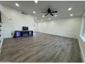 Spacious living room featuring modern floors, recessed lighting, a fireplace, and several windows at 5431 W Cholla St, Glendale, AZ 85304