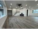 Bright and spacious living room with modern floors, recessed lighting, and sleek staircase at 5431 W Cholla St, Glendale, AZ 85304