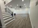 Bright and spacious living room featuring modern floors, recessed lighting and decorative staircase at 5431 W Cholla St, Glendale, AZ 85304