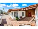 Home featuring a red tile walkway and roof, a covered front entrance, and desert landscaping at 5434 E Acoma Dr, Scottsdale, AZ 85254