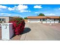 This home boasts a long driveway leading to a two car garage and beautiful desert landscaping at 5434 E Acoma Dr, Scottsdale, AZ 85254