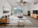 Bright living room featuring neutral furniture, decorative rug and plant accents at 5654 W Villa Theresa Dr, Glendale, AZ 85308