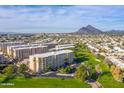 Expansive aerial view showcasing the residential building complex with mountain views in the background at 7930 E Camelback Rd # 409, Scottsdale, AZ 85251