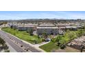 Overhead view of condos backing up to a golf course and a busy street, surrounded by city views at 7930 E Camelback Rd # 409, Scottsdale, AZ 85251
