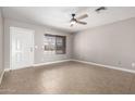 Light and airy living room featuring tile flooring, a ceiling fan, and a window with blinds at 8014 W Mescal St, Peoria, AZ 85345