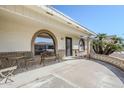 Inviting covered front porch with seating area and decorative brickwork at 8320 E Nido Ave, Mesa, AZ 85209