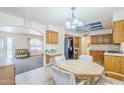 Eat-in kitchen featuring oak cabinets, black appliances, and tiled flooring at 8320 E Nido Ave, Mesa, AZ 85209