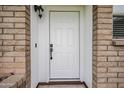 Close-up of a white front door framed by brick walls and white trim, offering a clean and inviting entrance at 903 W Barrow Dr, Chandler, AZ 85225