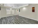 Living room featuring laminate flooring, neutral paint, and recessed lighting at 9230 N 82Nd Ln, Peoria, AZ 85345