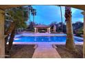 Backyard pool and spa with a gazebo-covered dining area provides a perfect space for relaxation and entertainment at 10365 E Paradise Dr, Scottsdale, AZ 85260
