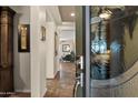 Inviting entryway featuring a decorative glass front door, tile flooring, and views of the home's interior at 10635 W Eucalyptus Rd, Peoria, AZ 85383