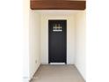 Inviting front door entry with a modern black door and minimalist design, creating a welcoming first impression at 11142 E Copper Dust Trl, Florence, AZ 85132