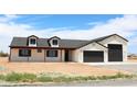 Charming single-story home with a 2-car garage and well-maintained front yard in a rural setting under a blue sky at 11142 E Copper Dust Trl, Florence, AZ 85132