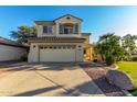 Inviting two-story home with neutral siding, a two-car garage, and well-maintained landscaping at 11713 W Tonto St, Avondale, AZ 85323