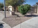 Landscaped front yard showcasing desert foliage and a two-car garage at 1875 N St Francis Pl, Casa Grande, AZ 85122