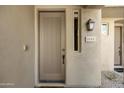 Close up of the front door featuring a craftsman style door, lantern fixture, and address plaque at 19475 N Grayhawk Dr # 2132, Scottsdale, AZ 85255