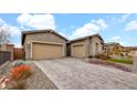 Beautiful home featuring a three-car garage, desert landscaping, and a paved driveway at 23434 N 76Th Way, Scottsdale, AZ 85255