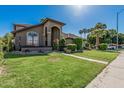 Expansive front yard showcasing a well-maintained lawn, mature palm trees, and inviting curb appeal at 3917 E Des Moines St, Mesa, AZ 85205