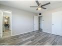 A bright bedroom with tiled floors, a ceiling fan, and multiple doors leading to other rooms at 4128 W Las Palmaritas Dr, Phoenix, AZ 85051