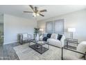 Bright living room with neutral colors, plush seating, ceiling fan, and modern decor at 4128 W Las Palmaritas Dr, Phoenix, AZ 85051