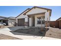 Single-story home with stucco finish, rock accents on columns, and a front porch with a view at 42405 W Krista Dr, Maricopa, AZ 85138