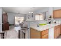 The kitchen overlooks the living area and features a breakfast bar at 45105 W Gavilan Dr, Maricopa, AZ 85139
