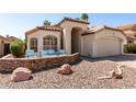 Charming single-story home featuring desert landscaping, a two-car garage, and a cozy seating area at the front of the property at 4779 W Tulsa St, Chandler, AZ 85226