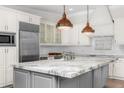 Stylish kitchen featuring a marble island, stainless steel appliances, and custom cabinetry at 6231 E Calle Camelia --, Scottsdale, AZ 85251