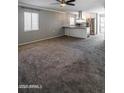 Spacious living room open to kitchen with carpet and ceiling fan at 6240 N 16Th St # 40, Phoenix, AZ 85016