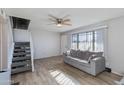 Living room features a cozy sofa and well-lit stairway access to the second floor at 6351 N 49Th Ave, Glendale, AZ 85301