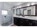 Modern bathroom featuring a double vanity, glass shower, and sleek tile accents at 7053 S Heather Dr, Tempe, AZ 85283