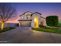 Charming two-story home featuring a well-manicured lawn and beautiful desert landscaping at dusk at 7053 S Heather Dr, Tempe, AZ 85283