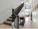 Bright hallway featuring tiled floors, staircase, and stylish décor leading to other rooms at 706 E Washington St # 204, Phoenix, AZ 85034