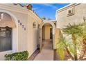 Welcoming front entrance showcasing a quaint, covered entryway with decorative features and desert landscaping at 7168 N Via De Amigos --, Scottsdale, AZ 85258
