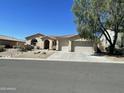 Charming single-story home with desert landscaping, three car garage, and tile roof at 10980 E Winchcomb Dr, Scottsdale, AZ 85255
