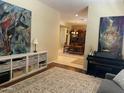 Open-concept living room with a dining room view and abstract art at 10980 E Winchcomb Dr, Scottsdale, AZ 85255